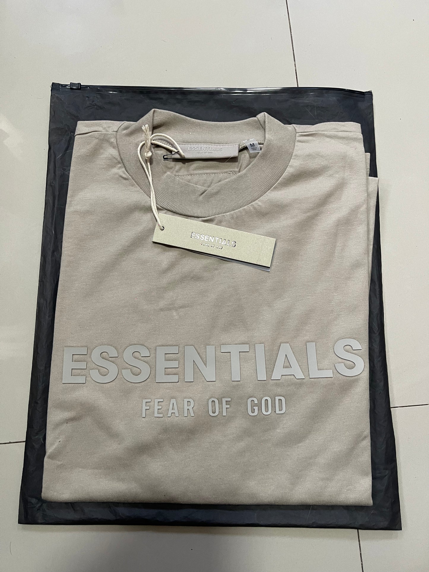 Fear of God Essentials middle logo ash