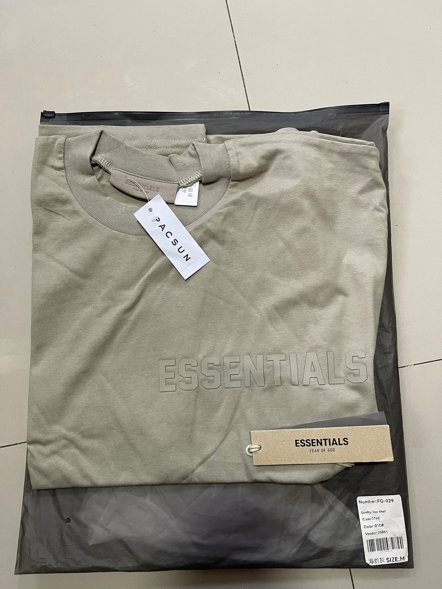 Fear of God Essentials side logo ash